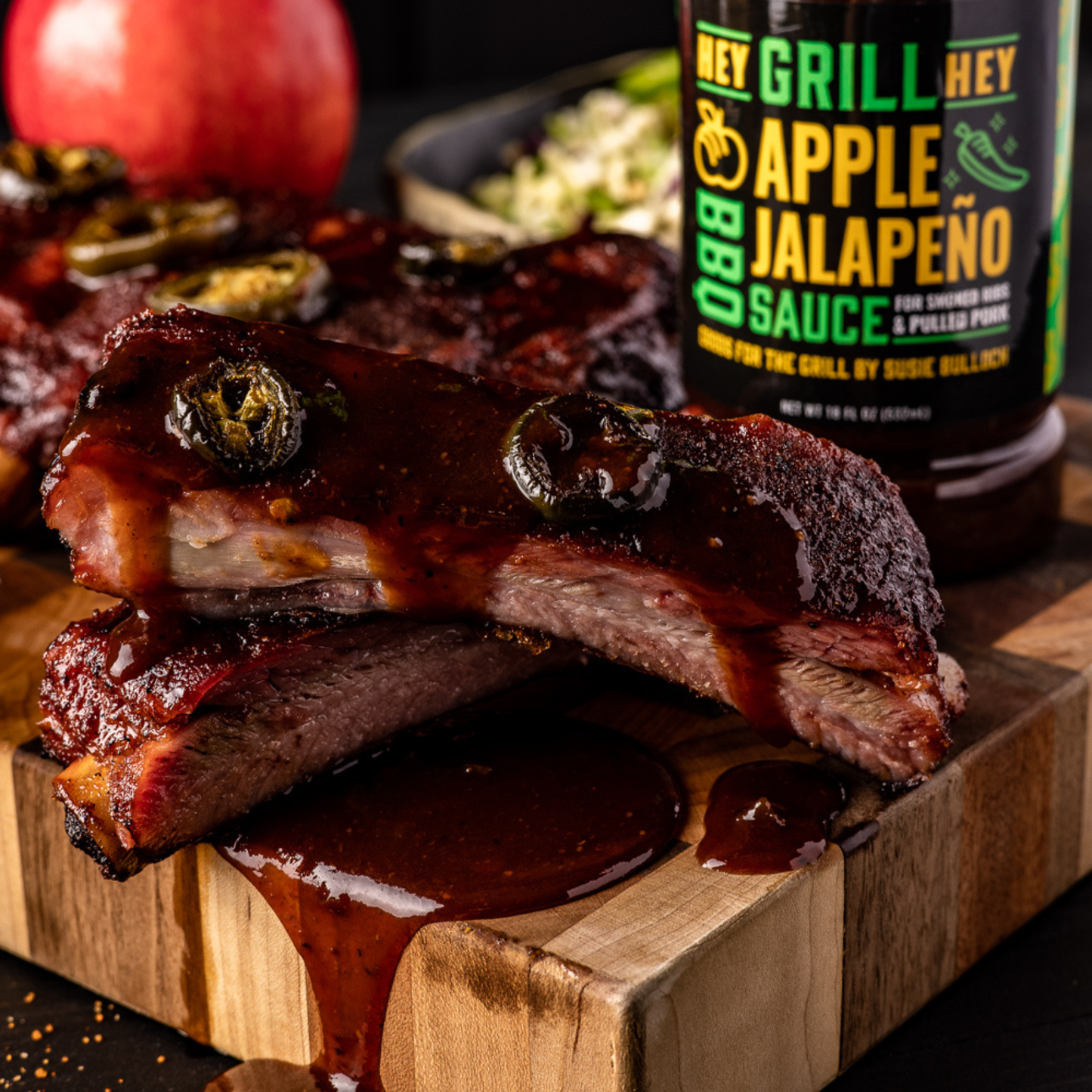 Cut ribs that have been covered in Apple Jalapeno BBQ Sauce sit on a cutting board..