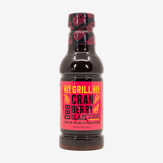 A bottle of Cranberry BBQ Glaze on a white background. 