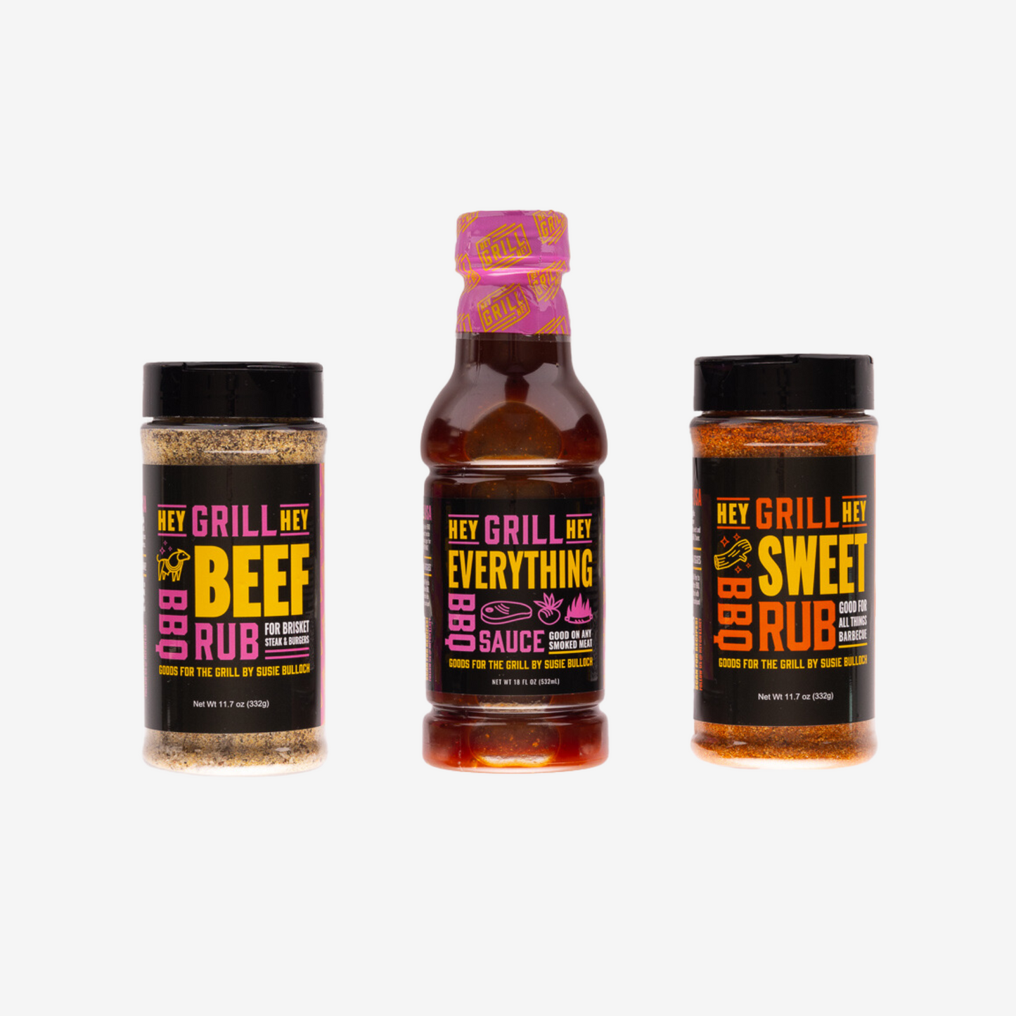 A bottle of Hey Grill Hey Beef Rub, a bottle of Hey Grill Hey Everything BBQ Sauce, and a bottle of Hey Grill Hey Sweet Rub lined up against a plain white background.