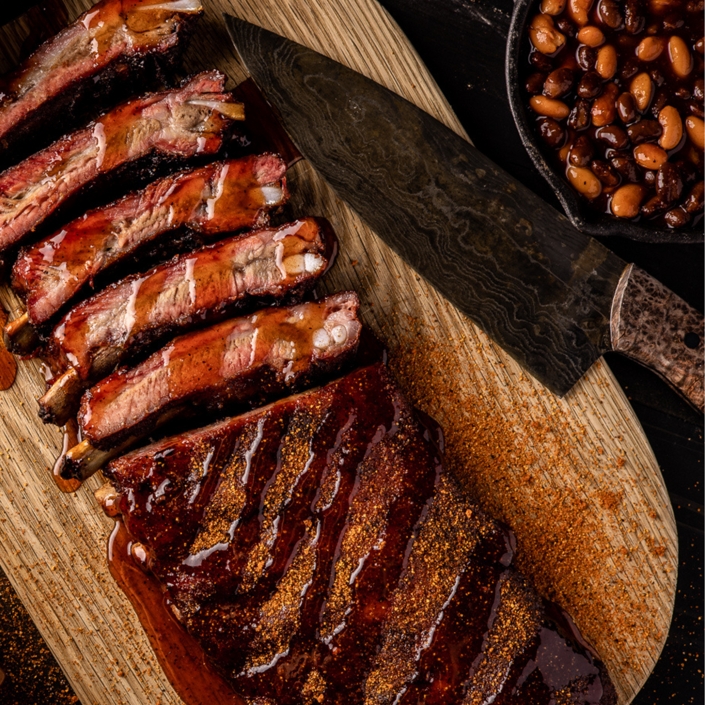 Smoked BBQ ribs with Maple Bourbon BBQ Glaze drizzled on top. 