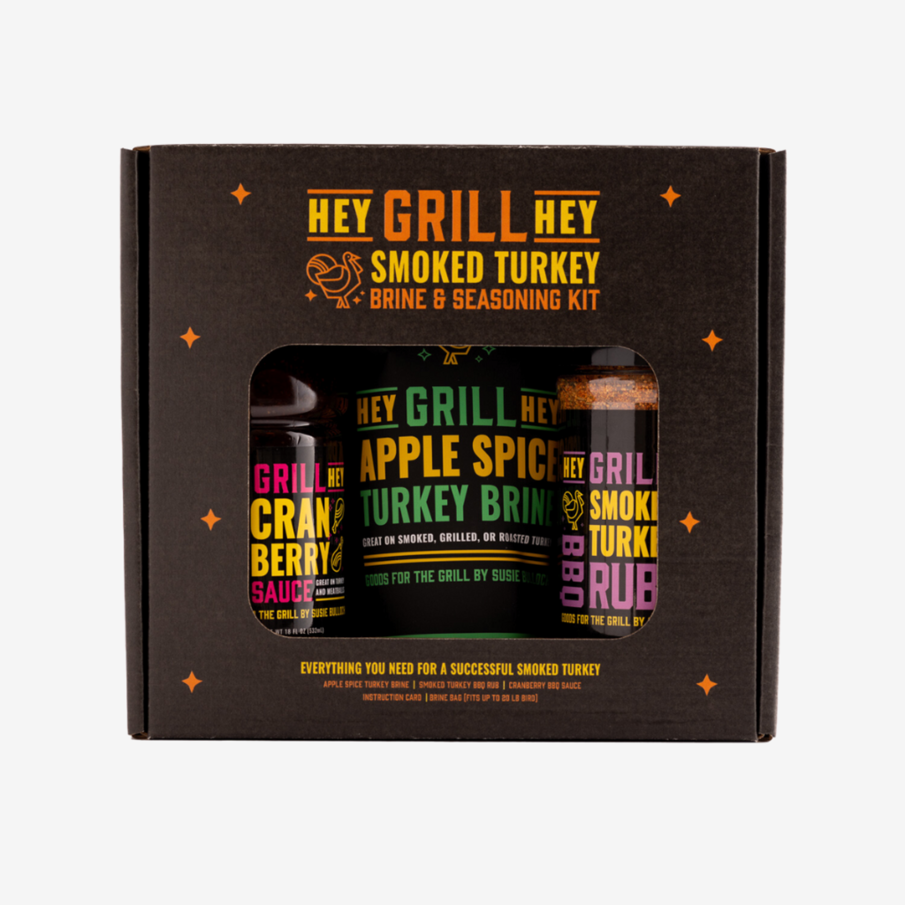 The box for the Smoked Turkey Brine and Seasoning Kit sits on a white background. Inside the box you can see the Cranberry Glaze, Apple Spice Turkey Brine, and Smoked Turkey Rub. The box says "Everything you need for a successful smoked turkey" 