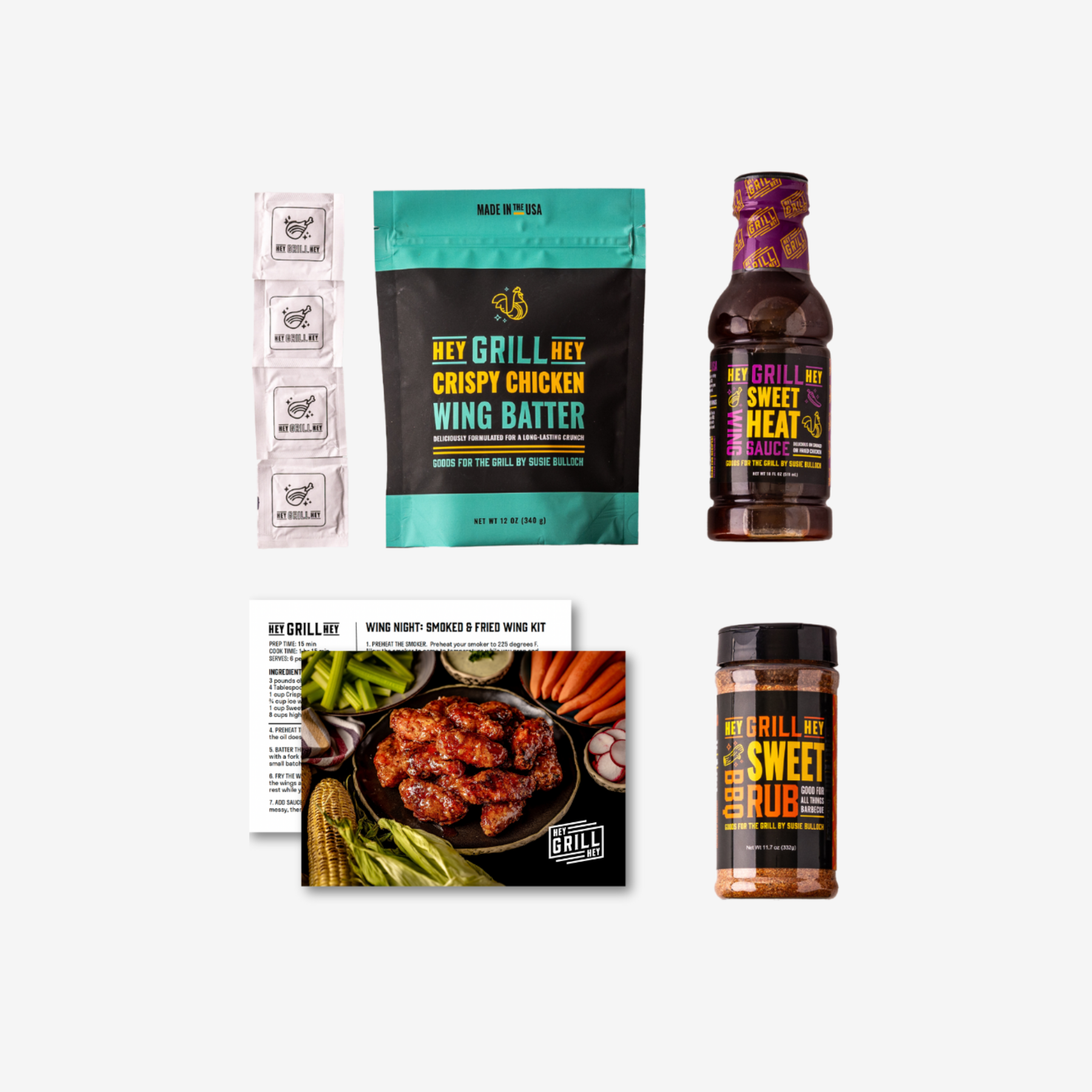 All the contents of the Wing Night kit laid out against a white background. Contents include 4 packaged wing wipes, a bag of Hey Grill Hey Crispy Chicken Wing Batter, a bottle of Hey Grill Hey Sweet Heat WIng Sacue, instruction cards, and a bottle of Hey Grill Hey Sweet Rub.